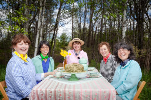 Around the Farm Table Host Inga Witscher, center, shares a cake that she prepared with some friends in Mondovi, Wisconsin. Photo By Collin Crowley.