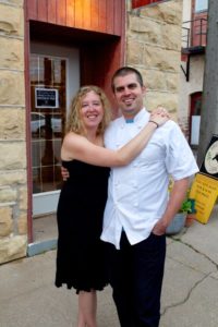 Ruthie Zahm and her beardless husband (in chef's whites) pose outside the cafe.