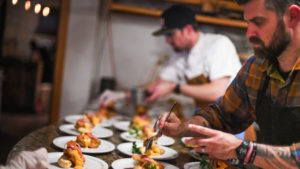 Luke and his staff prepare dozens of plates for a dinner