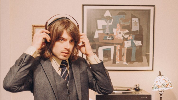 Photo of musician, Neal Francis, with headphones on.