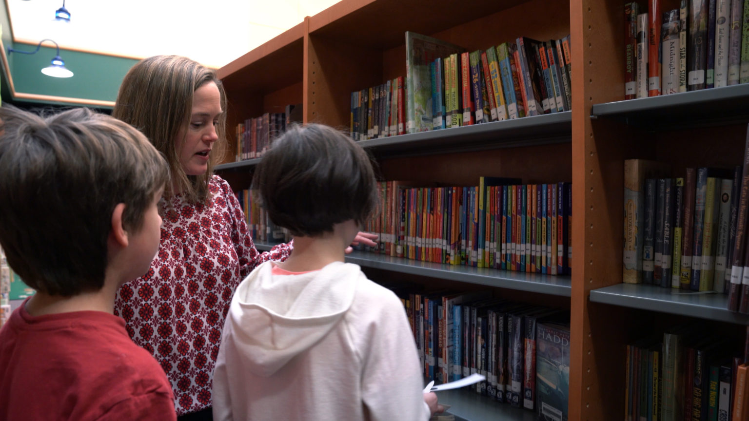 Instructor from Elmbrook School District in the library with students