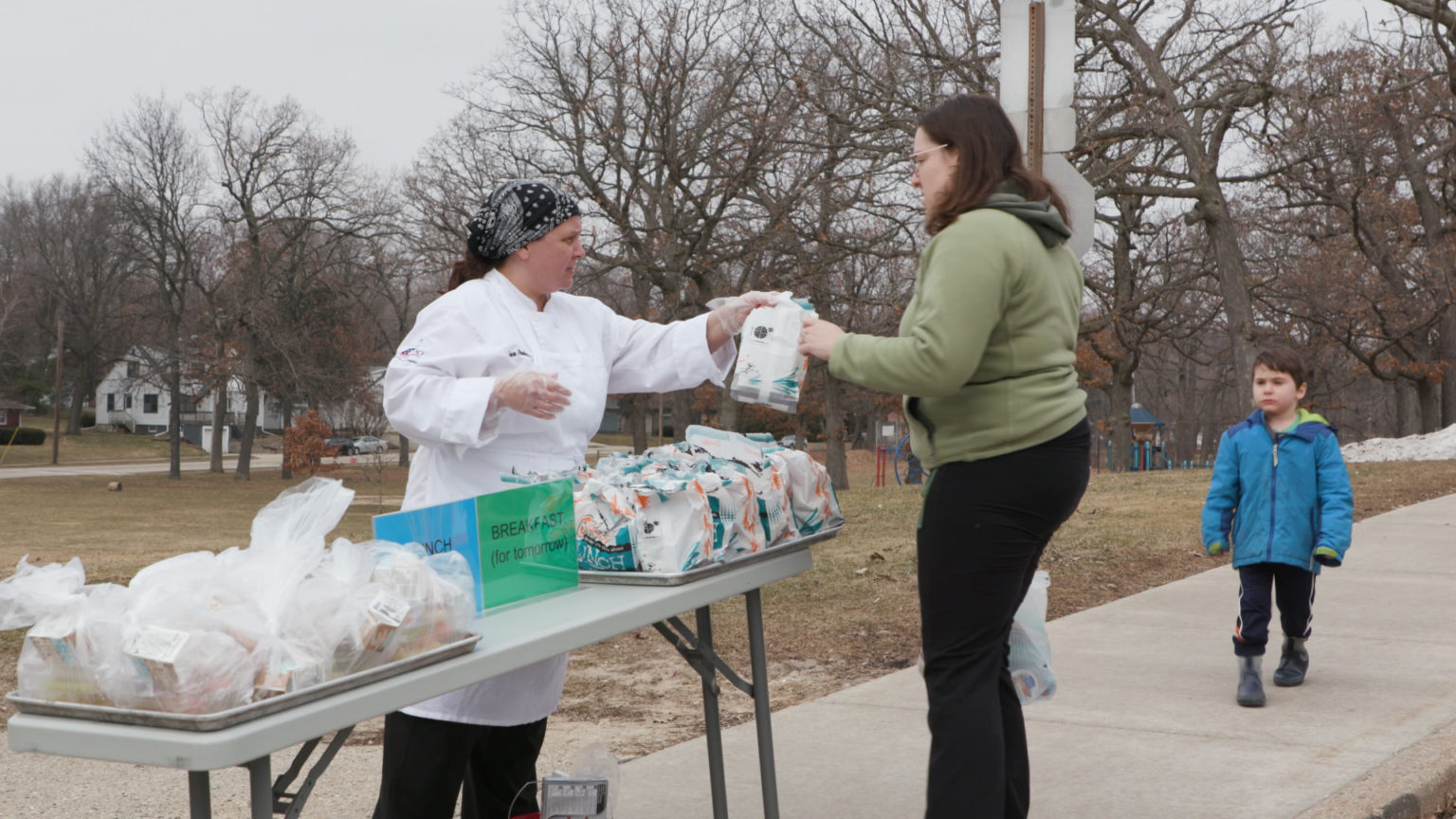 District parent receives school lunch on March 16, 2020 in Madison while schools are shut down due to novel coronavirus. 