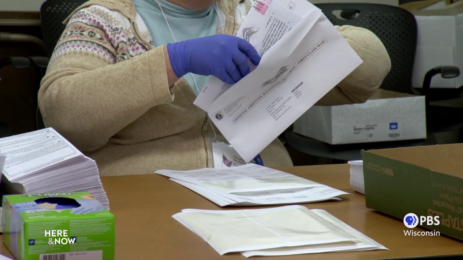 A city official prepares an absentee ballot in Madison.