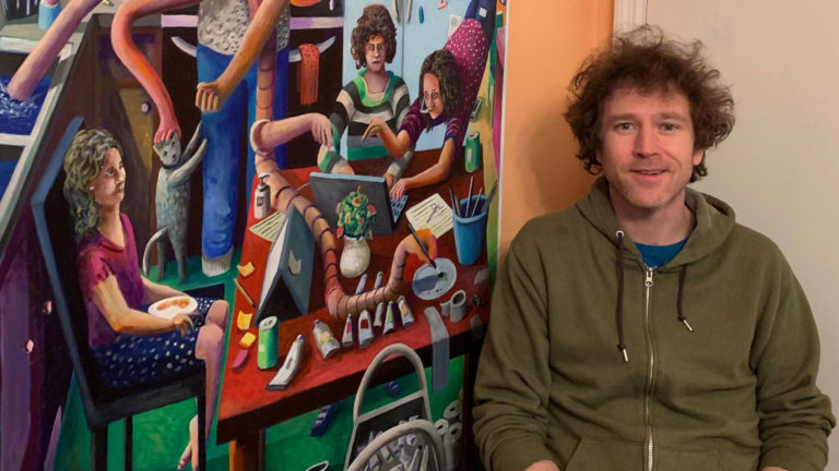 Artist Leif Larson of Oshkosh at home in his kitchen artist’s studio with his painting “Family Life During A Pandemic.”