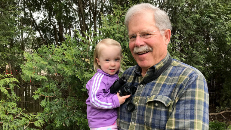 John Gurda holding his granddaughter