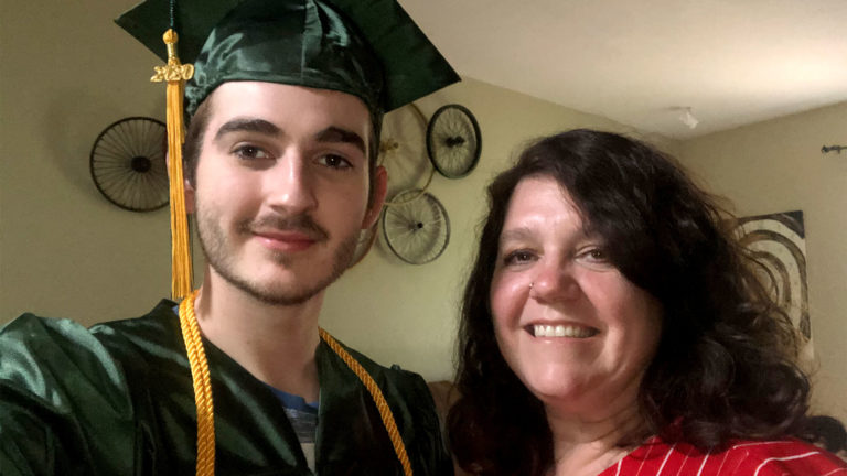 Image of Daniel Croake in Graduation Cap and Gown with mother Shelia Petitjean