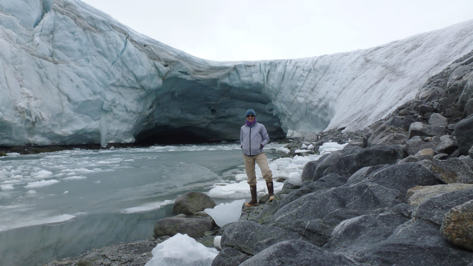 Woman standing in front of glacier