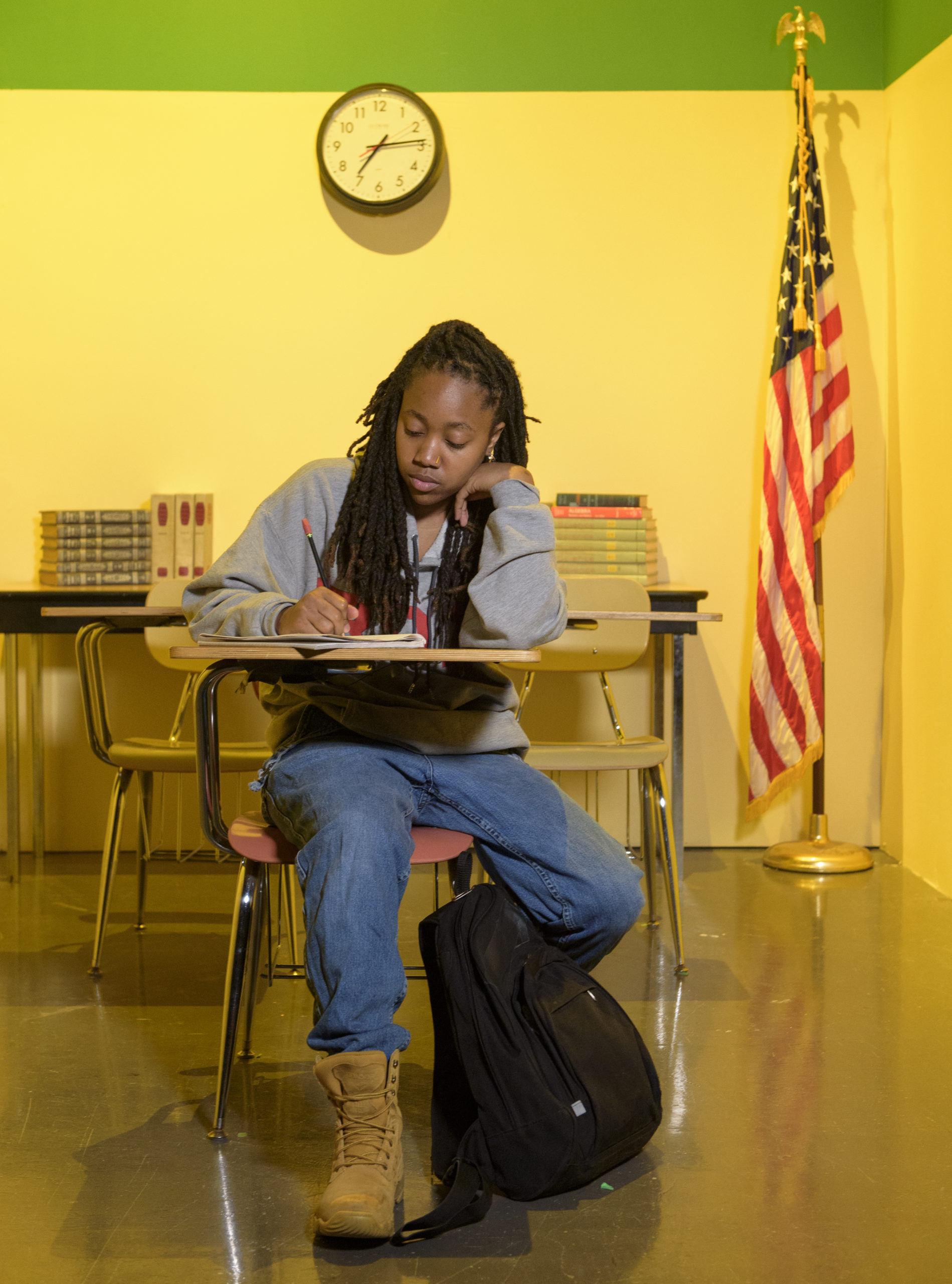 Zhalarina Sanders sits at her classroom desk.