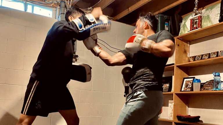 Two fighters training in a basement