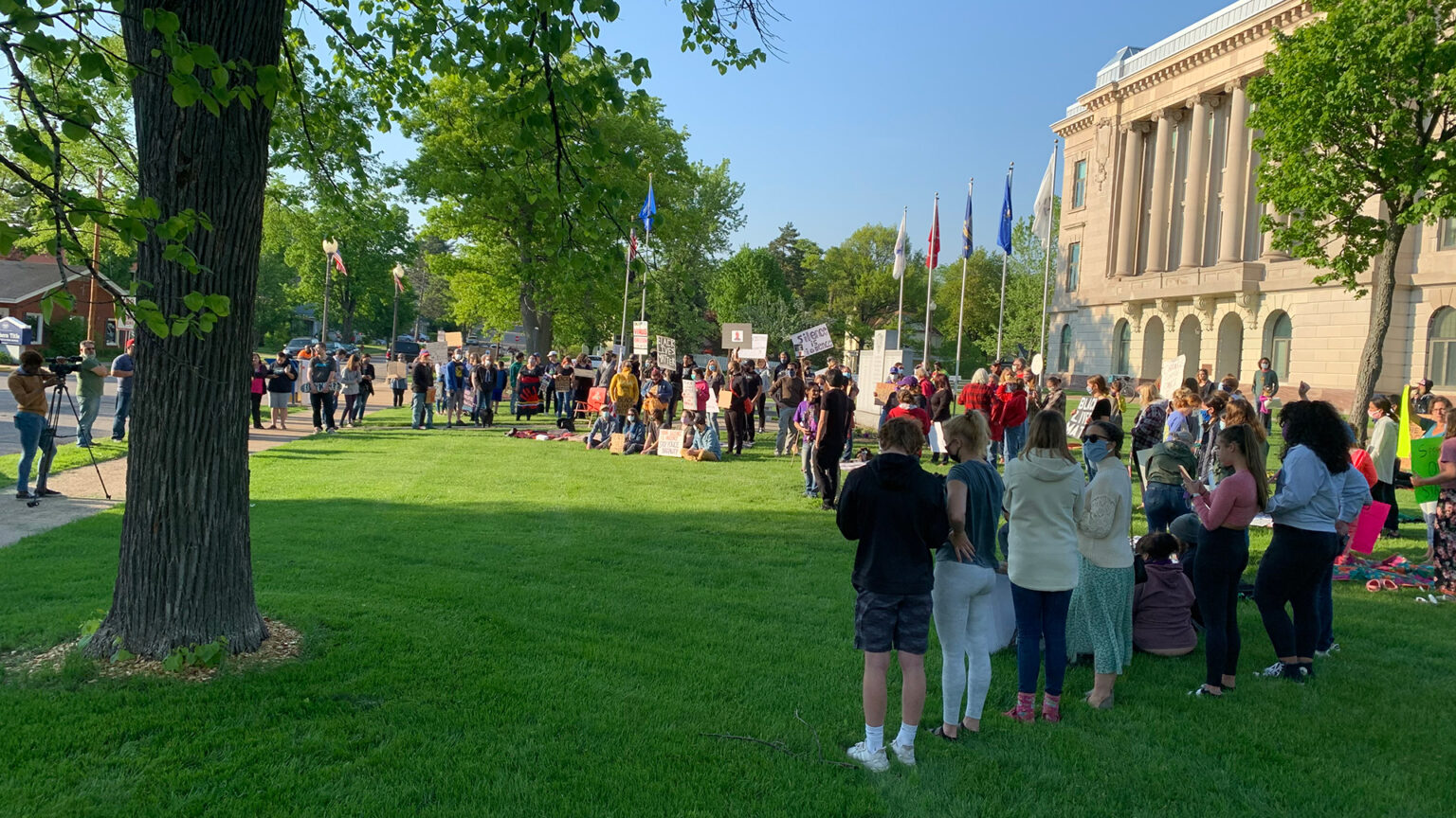 Protestors gather in front of a courthouse. 