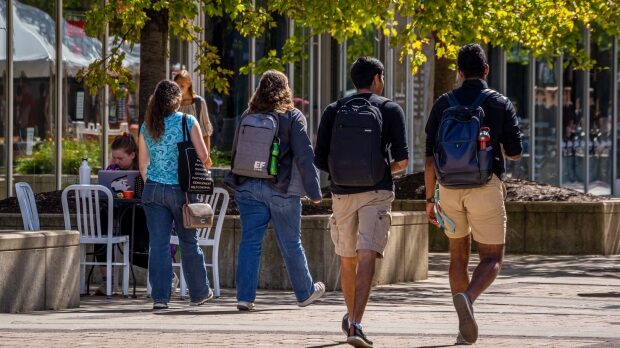 Students walking on East Campus Mall on the University of Wisconsin-Madison campus. (Courtesy: Bill Martens / WPR)