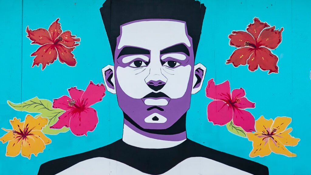 Mural large-scale painting of a young Black man surrounded by flowers