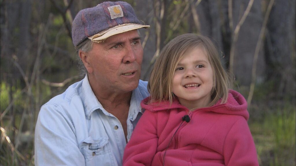 A man holds a child on his lap