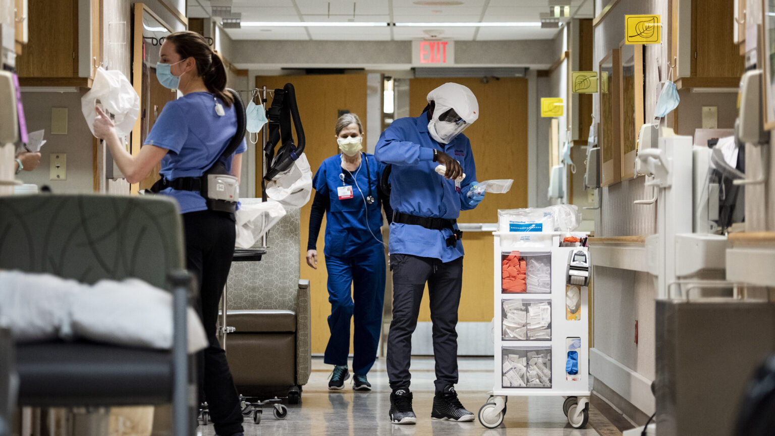 Healthcare workers wearing masks in a hospital hallway