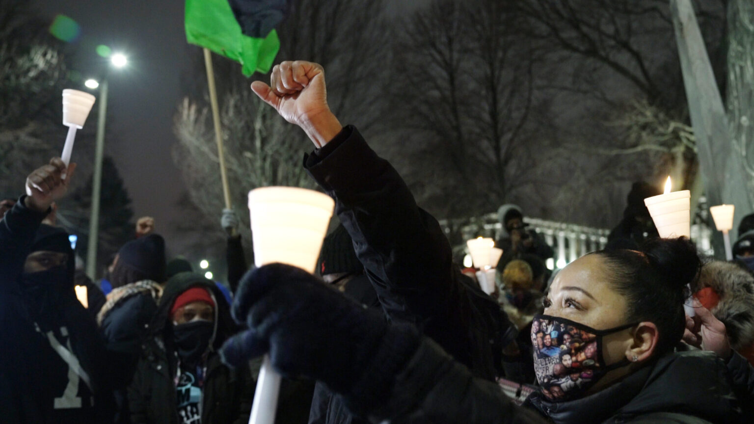 Community members hold a moment of silence Monday during a candlelight vigil for Jacob Blake. Photo by Marisa Wojcik.