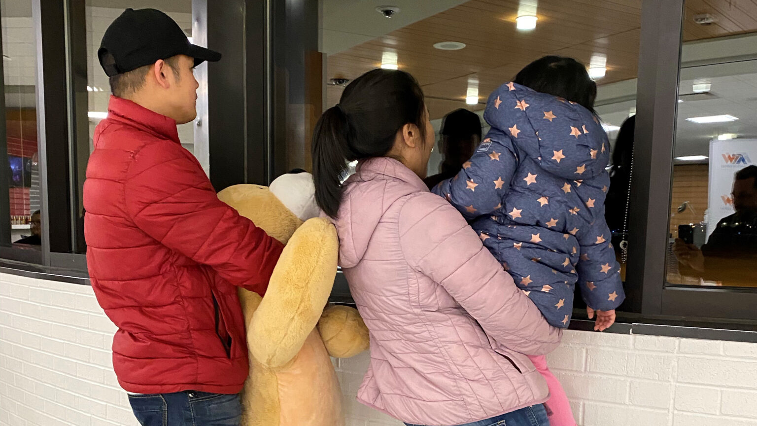 Relatives wait at an Appleton airport for the arrival of a refugee