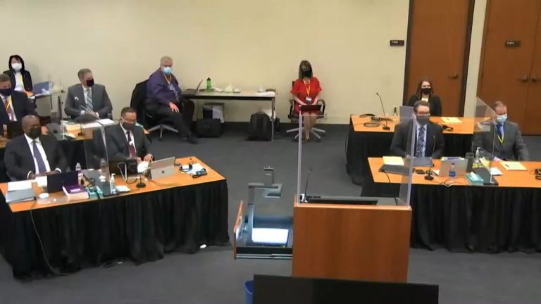 Courtroom for the Derek Chauvin trial, with distanced tables and speaking shields as pandemic precautions