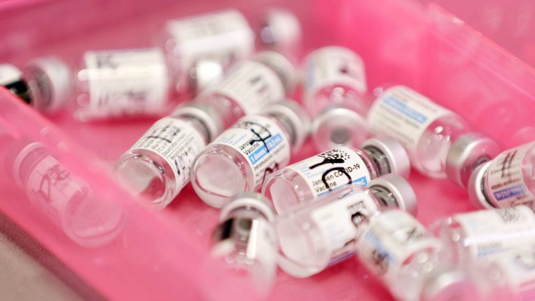 Vials of Johnson & Johnson coronavirus vaccine doses sit in a tray