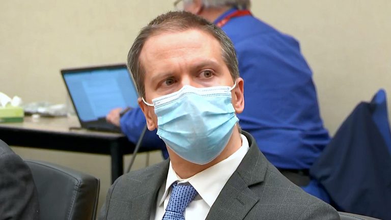 Derek Chauvin wears a face mask in a courtroom as verdicts are read.