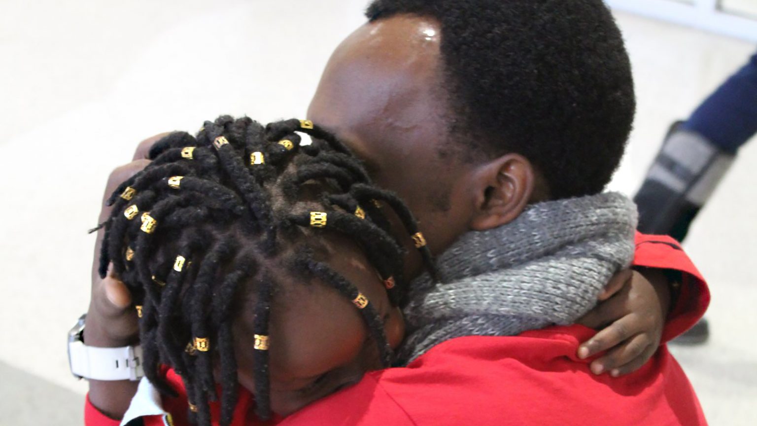 A hug between a father and young daughter