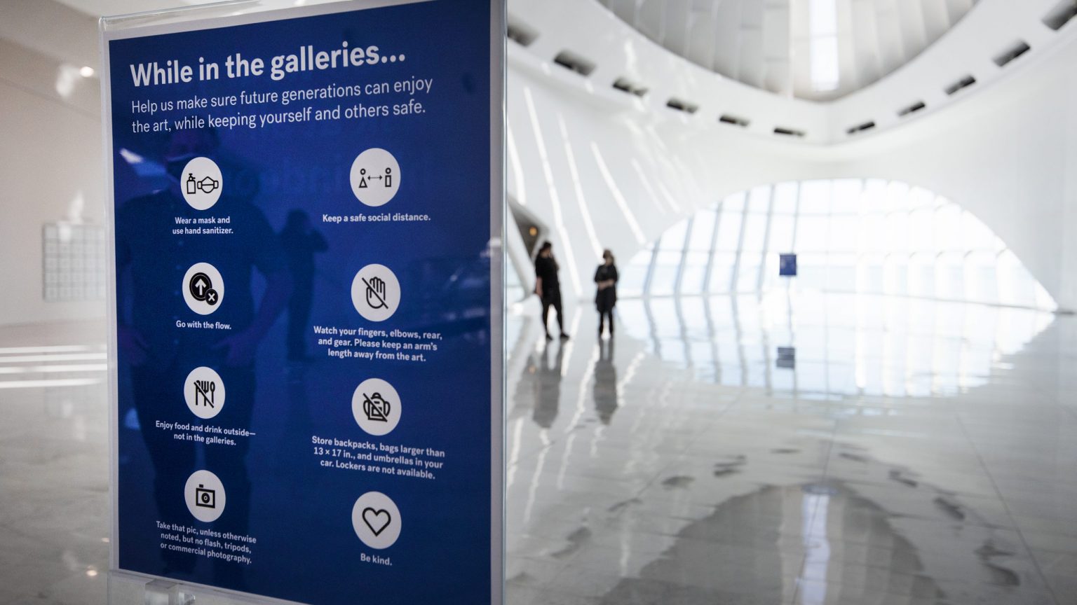 A sign instructs on safety protocols near the entrance to the Milwaukee Art Museum