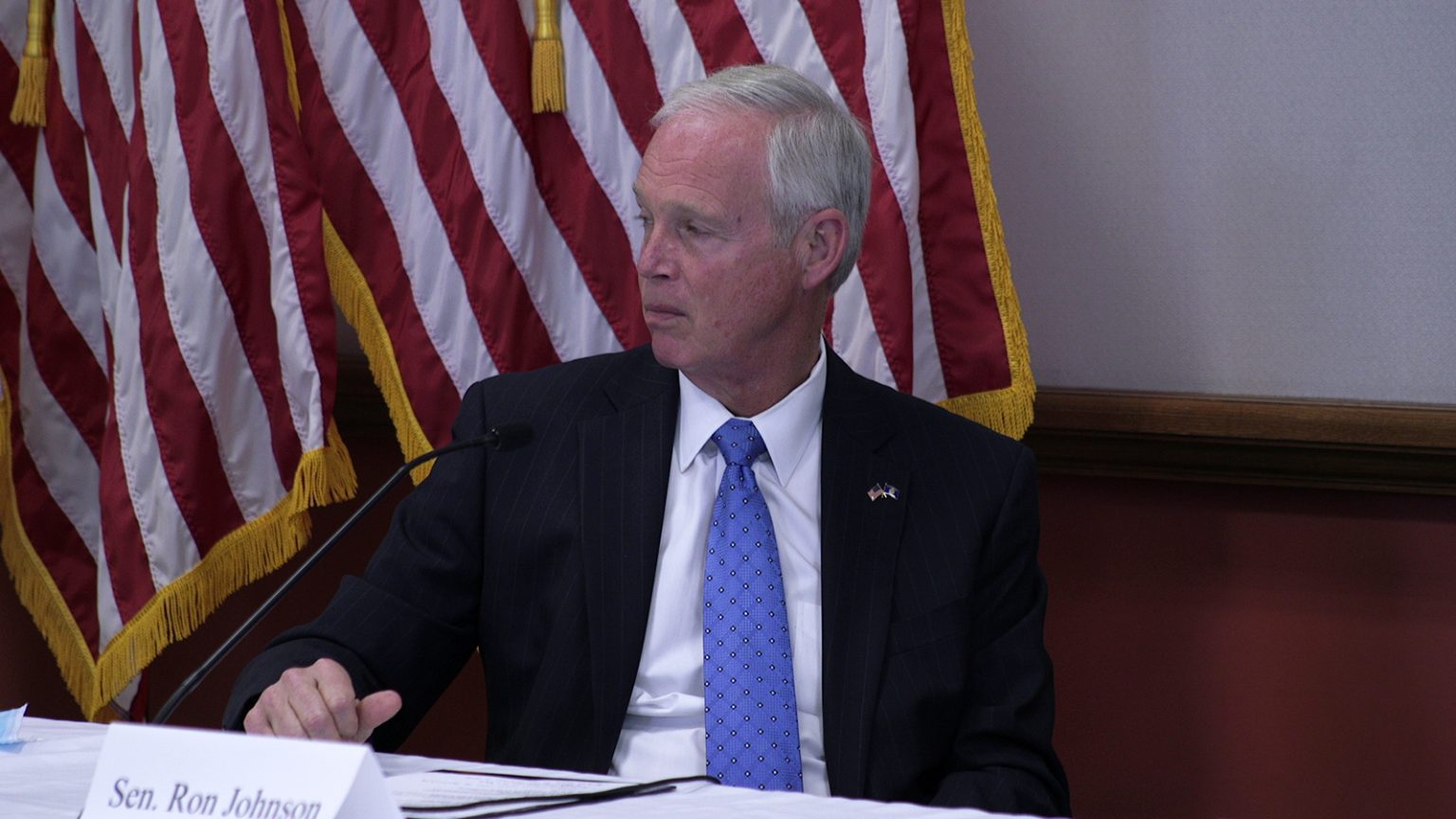 Ron Johnson sitting at table.