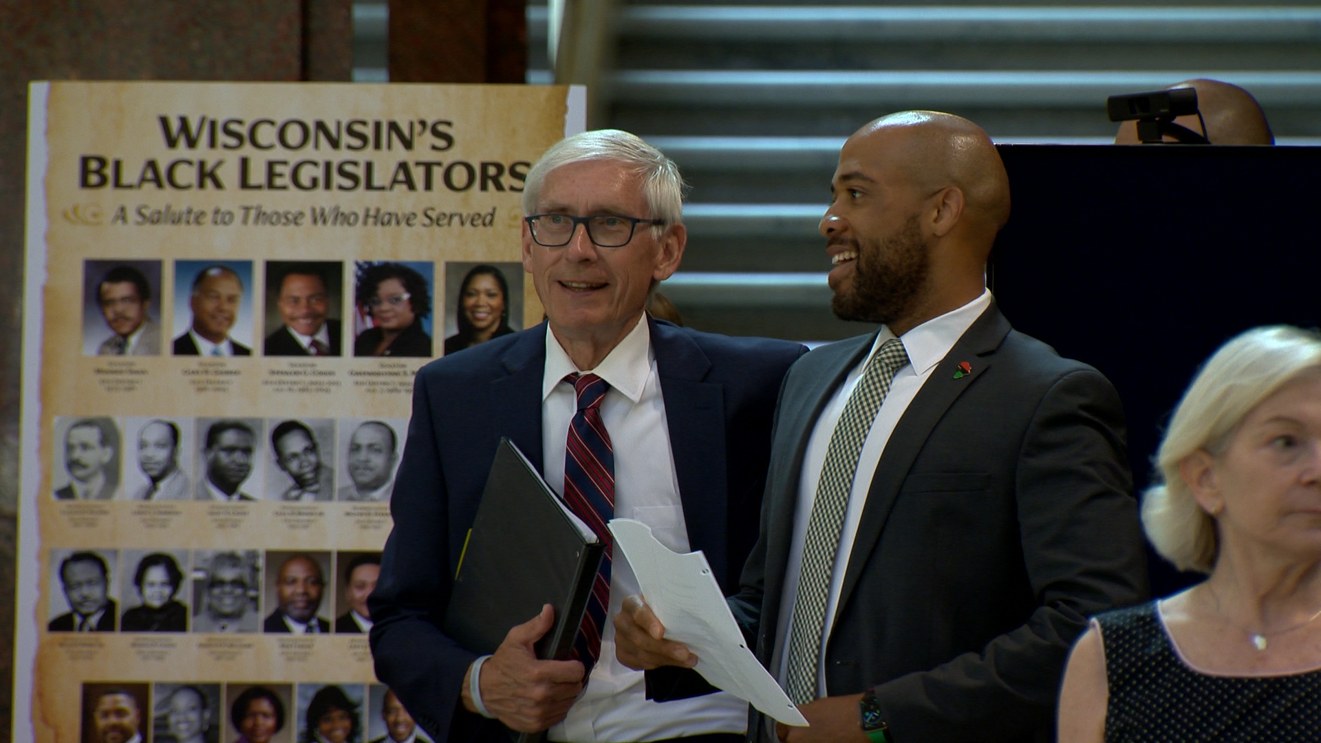 Tony Evers and Mandela Barnes stand next to each other inside the Wisconsin Capitol