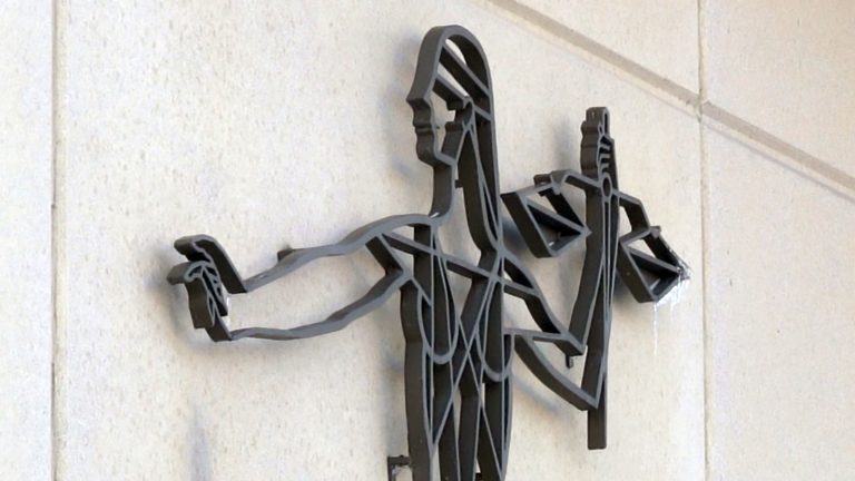 Illustration based on Lady Justice sculpture on wall of Dane County Courthouse in Madison