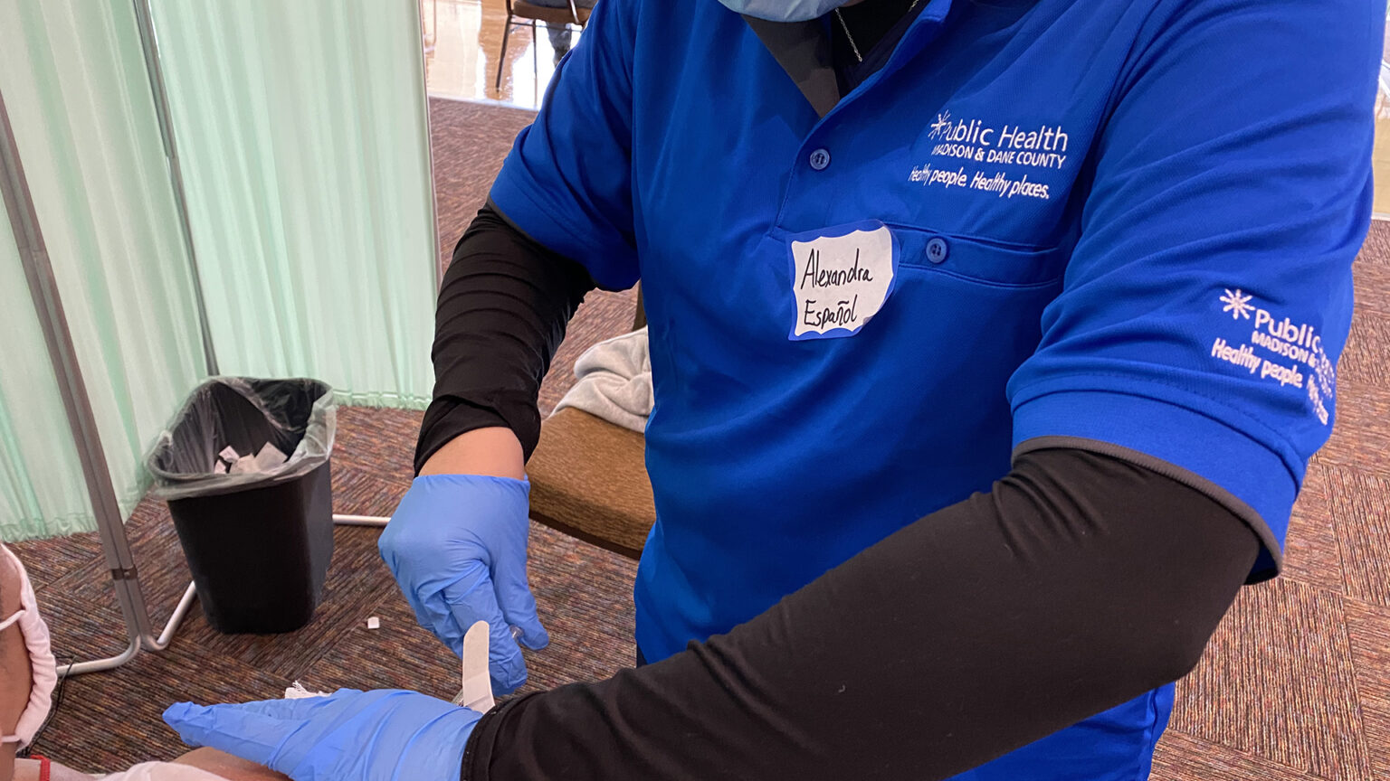A Public Health Madison & Dane County vaccinator administers an injection.
