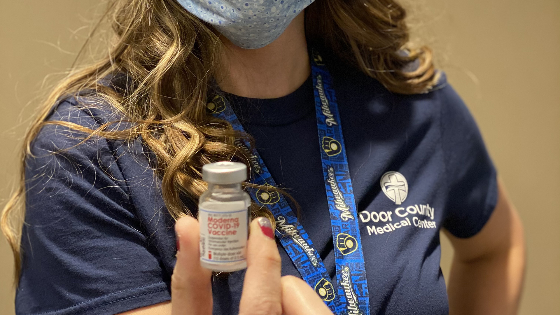 A Door County Medical Center staffer holds a vial of a COVID-19 vaccine.
