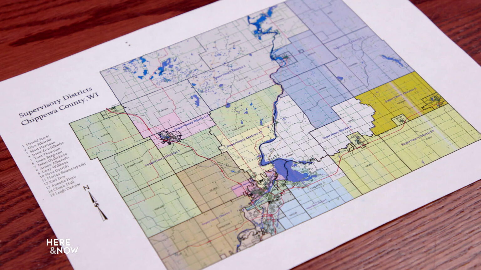 A map of Chippewa County supervisory districts sits on a table.
