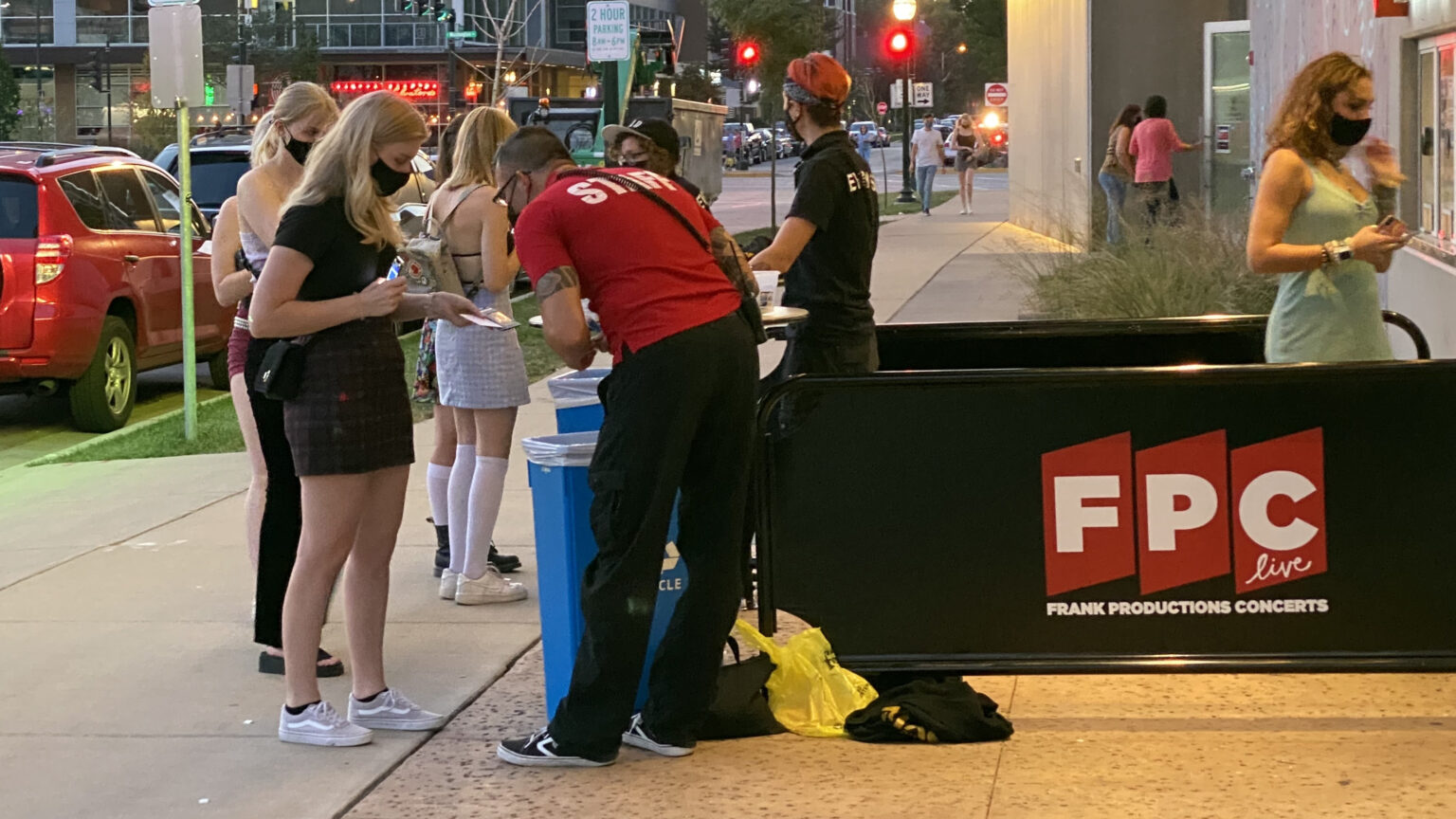 Staff members check IDs and proof of vaccine cards of concert-goers outside a venue in downtown Madison, Wisconsin.