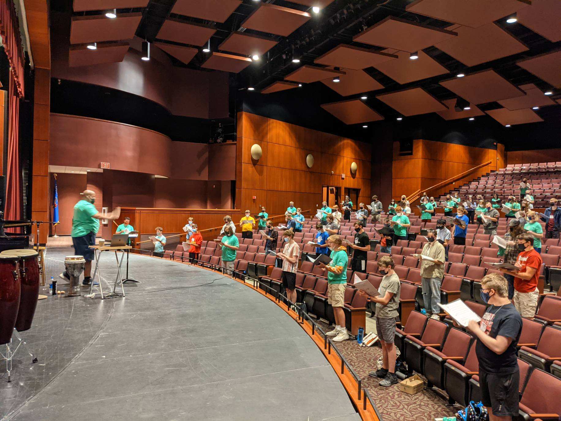 The 2021 WSMA Mixed Choir practicing in an auditorium