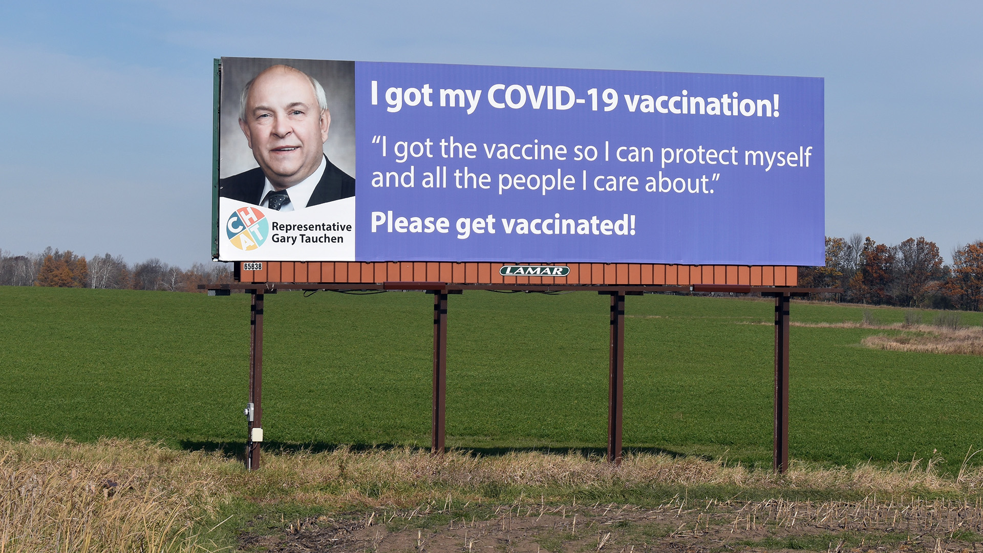A billboard standing in a farm field reads: "I got my COVID-19 vaccination! "I got the vaccine so I can protect myself and all the people I care about." Please get vaccinated!