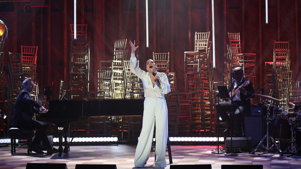 A solo female singer performs on stage.