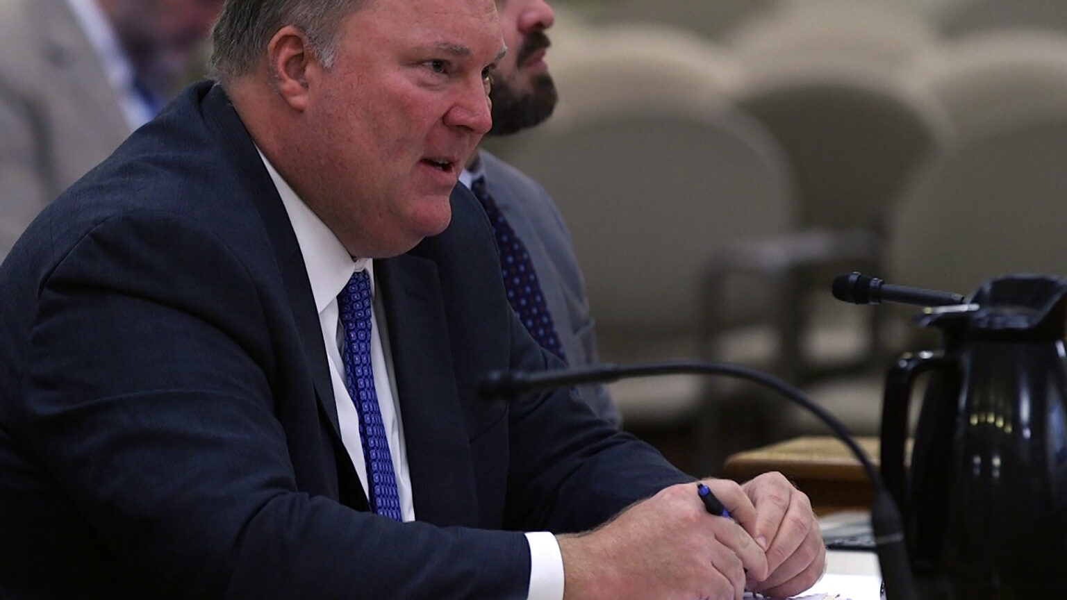 Michael Gableman is seated at a table and speaks into a microphone.