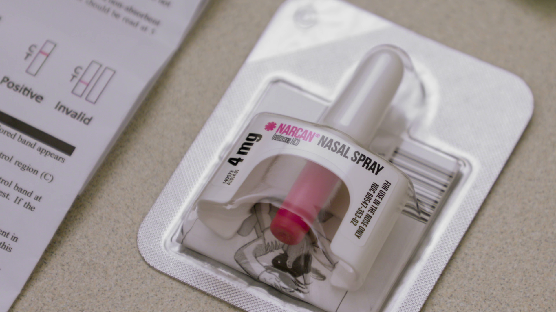 A plastic blister pack encases a 4 mg dose of Narcan nasal spray.