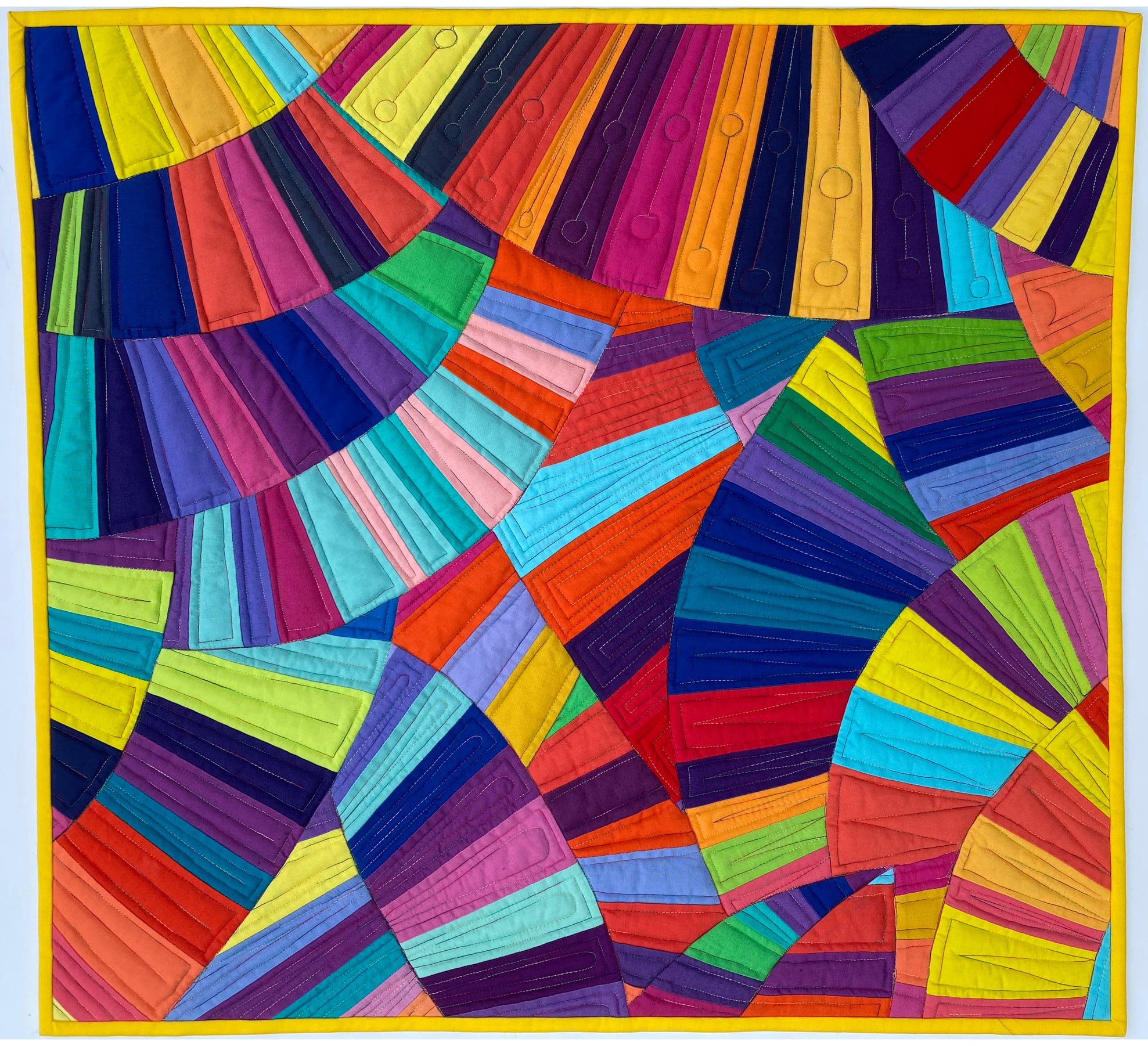 Layers of bright, multicolored fans stitched into a quilt