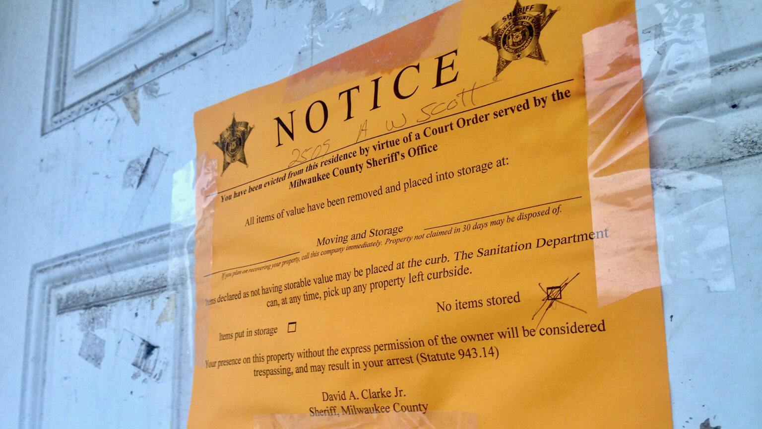 An eviction notice is posted on a door.