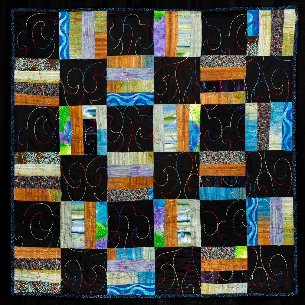 Picket fence quilt with multi-color and black blocks