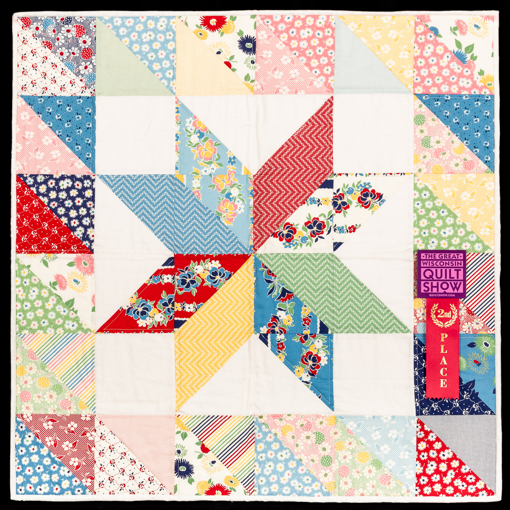 An eight star quilt in warm pastel colors