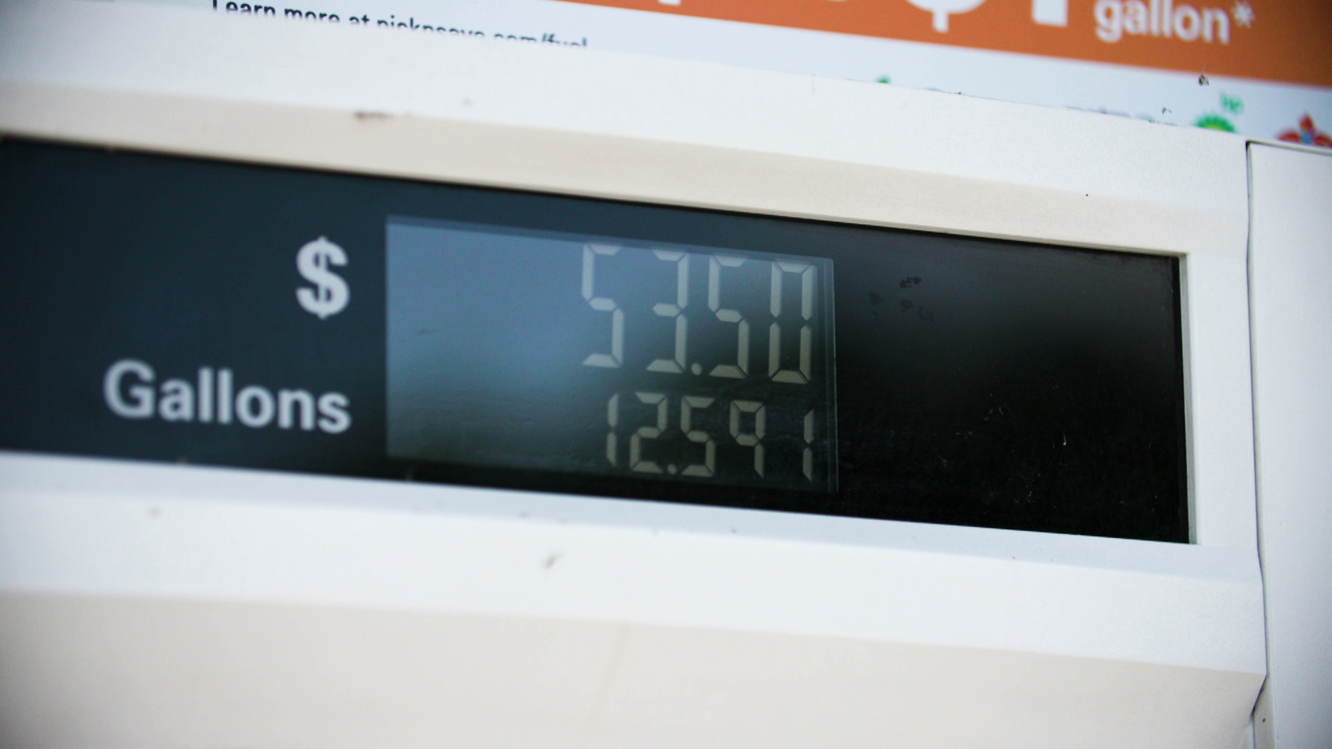A gasoline pump display shows a price of $53.50 for 12.591 gallons.