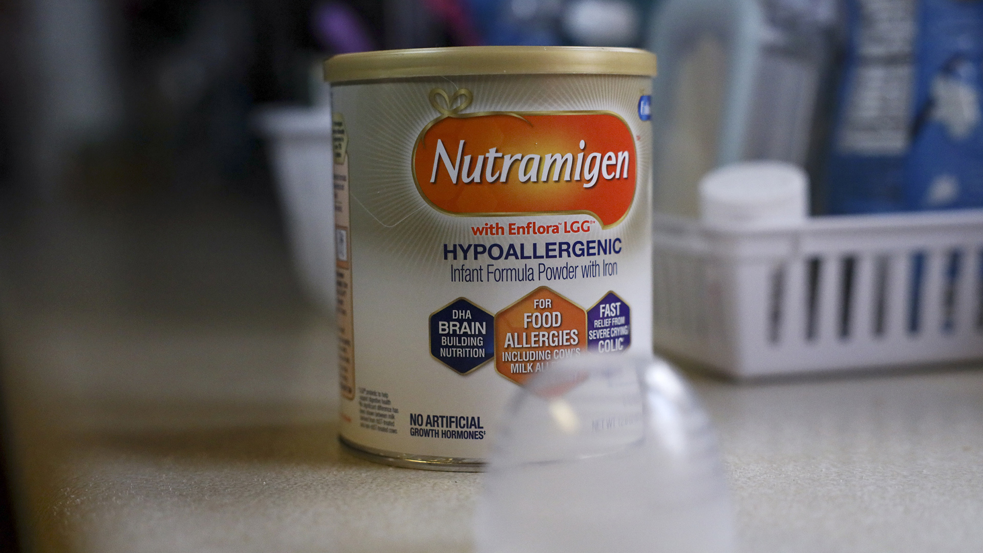 A canister of Nutramigen formula sits on a kitchen counter.