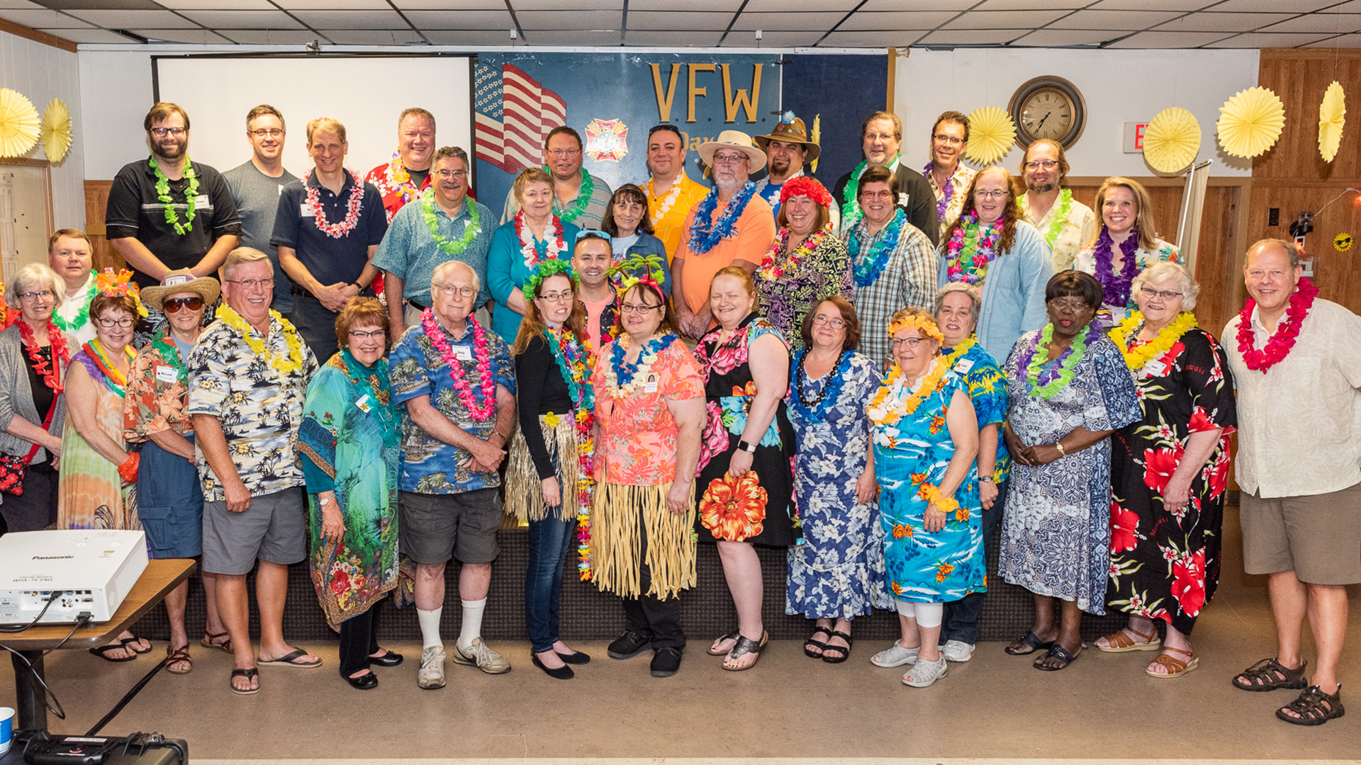 A group shot of PBS Wisconsin volunteers dressed for a Hawaiian luau