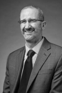 Black and white portrait of Managing Director of Individual Giving, Clint Walz