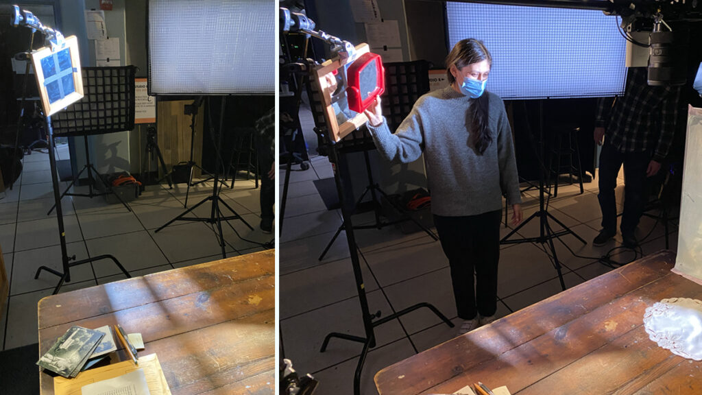 A mirror with tape creates a window-like shadow on a table and a woman holds a mirror to experiment with lighting.