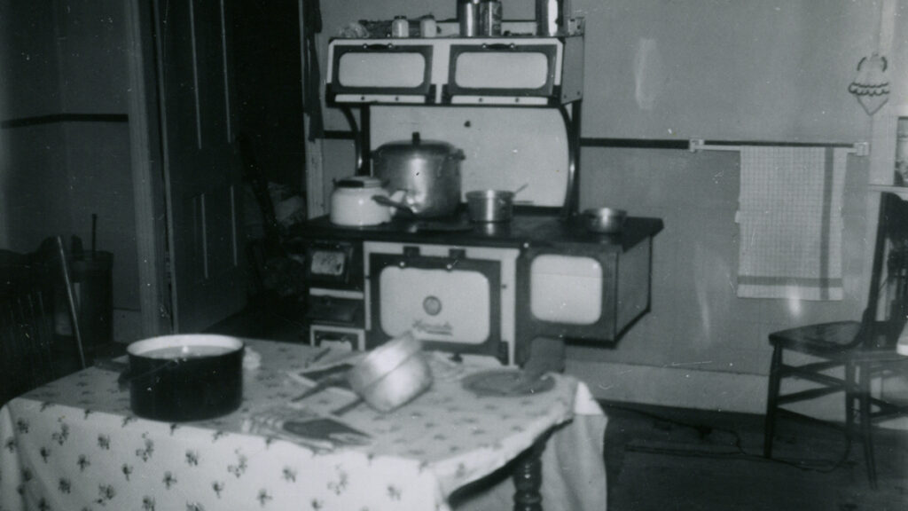 A black and white picture of an old farmhouse kitchen