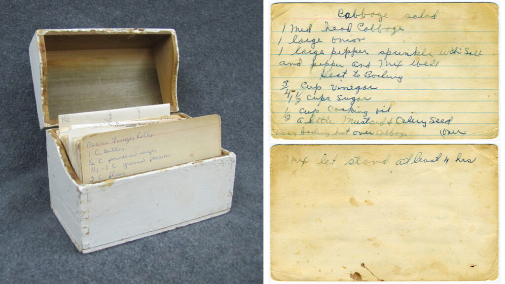 An old white recipe box filled with index cards next to a recipe written out on an index card