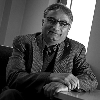 Black and white photo of man (Masood Akhtar) sitting