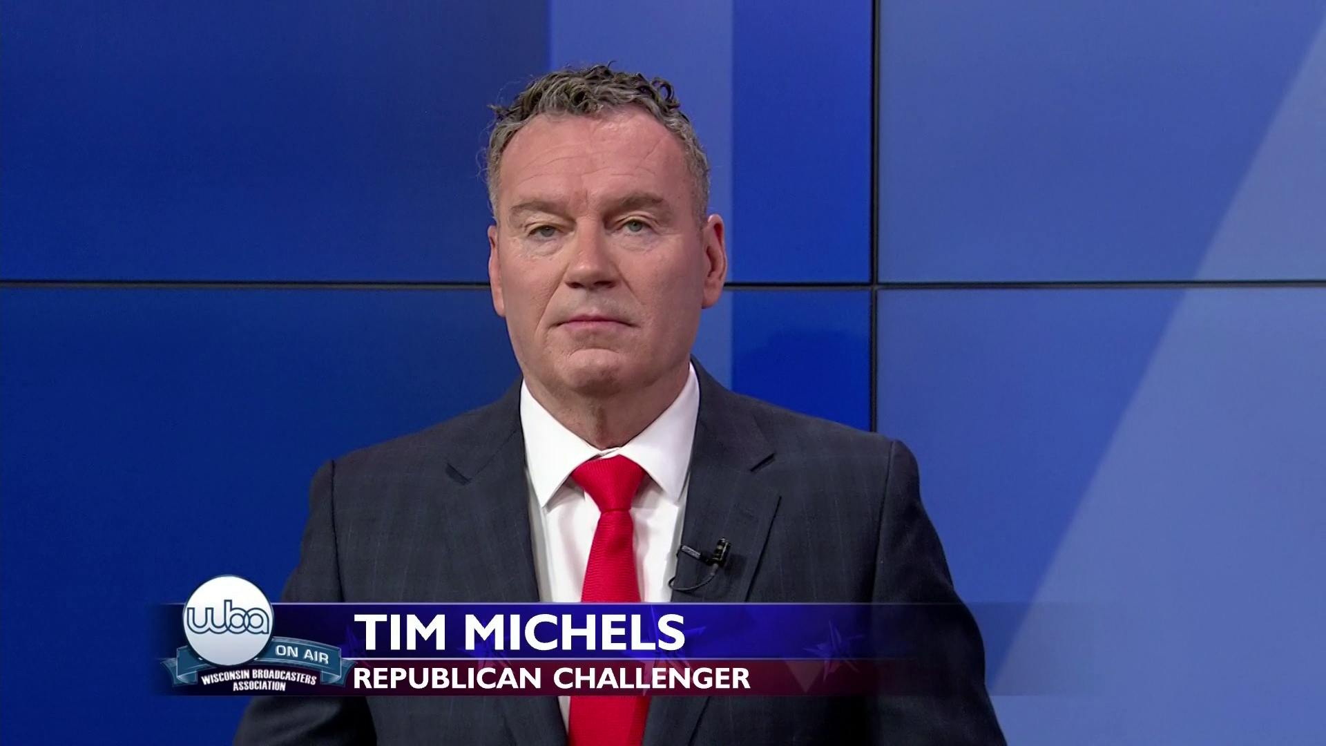 Tim Michels faces a camera during a televised debate.
